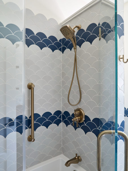 Shower featuring half round fish scale tile