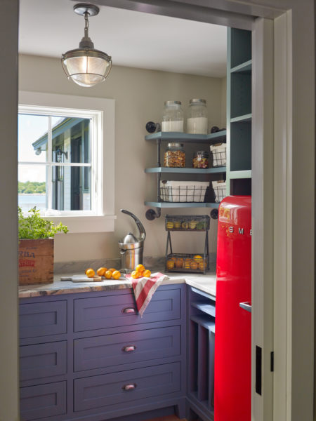 view from the hall of the pantry with custom cabinetry in a coastal blue color