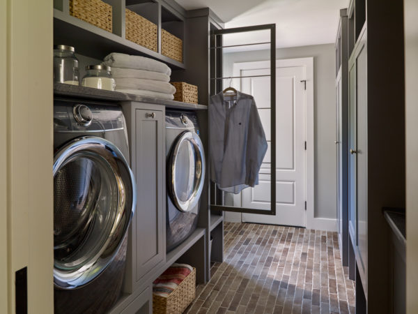 Laundry room featuring custom cabinetry with plenty of storage