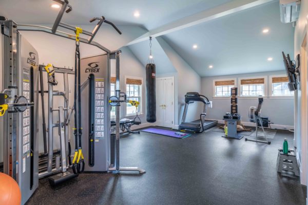 Home gym with slanted ceilings and gym flooring