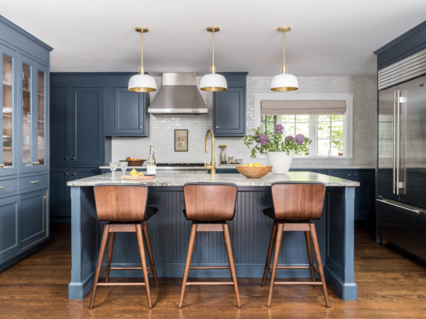 Blue paneled kitchen island with dome lights