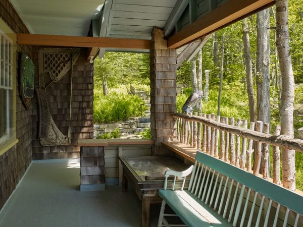 A view of the porch with natural Birch logs utilized as the railing