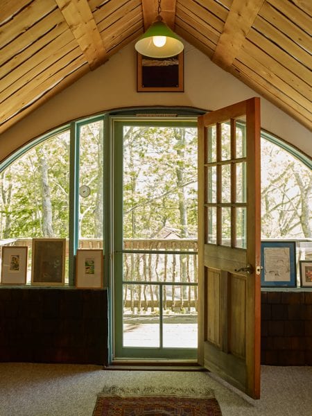 Cabin inspired cathedral ceilings with curved picture windows