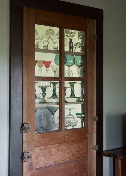 Fancy antique locks and hinges on Dutch doors to the built-in shelving