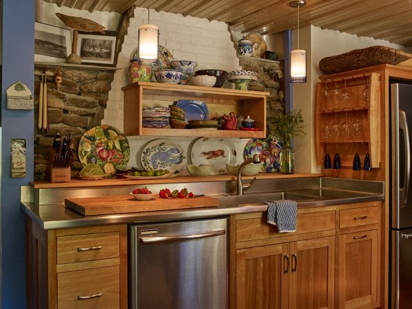 Stone, brick, tin, wood, and stainless steel pull this kitchen together