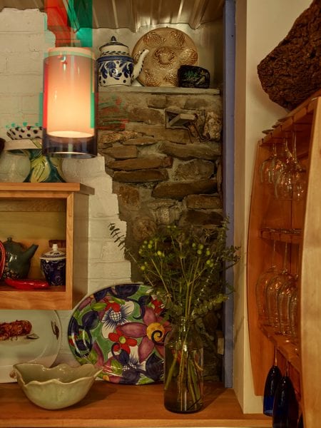 Brick, stone, tin, and wood materials are used to create shelving at the Mt. Pisgah property