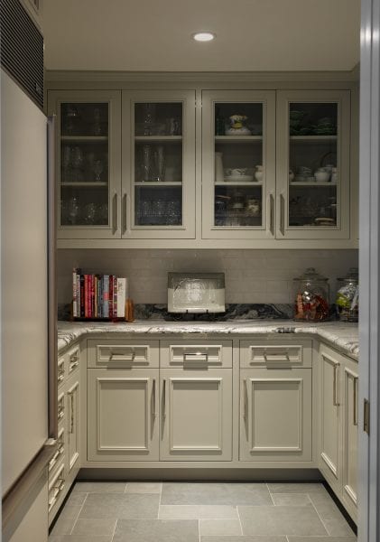 A pantry with cabinets and counterspace for storage.