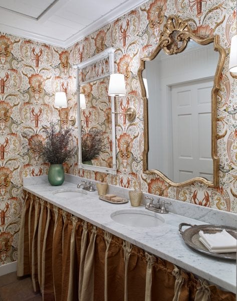 Wallpapered powder room with mismatched mirrors