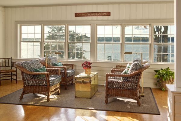 Wicker chairs in wood paneled living room