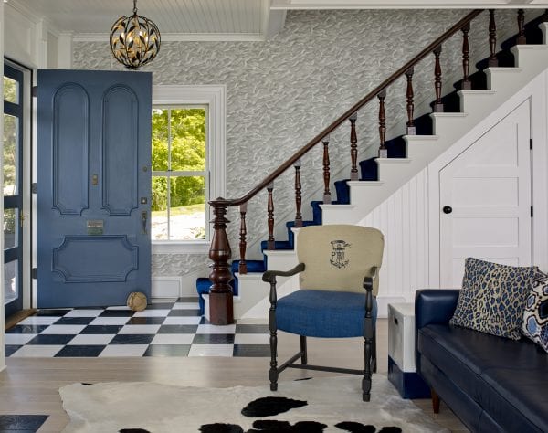 Staircase leading to the entryway with unique theme.