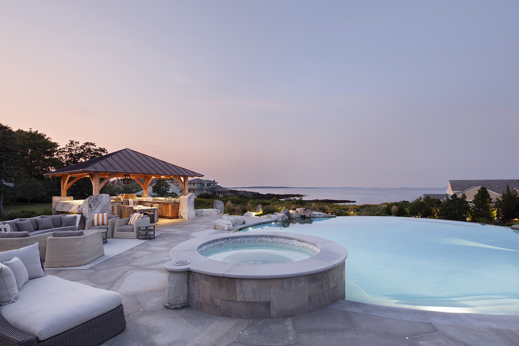Hot tub and pool with view of coastal Maine.