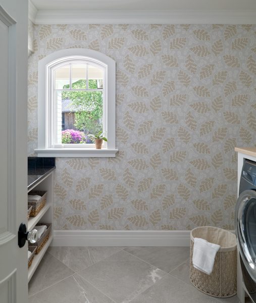 View of curved window and botanical wallpaper in laundry room