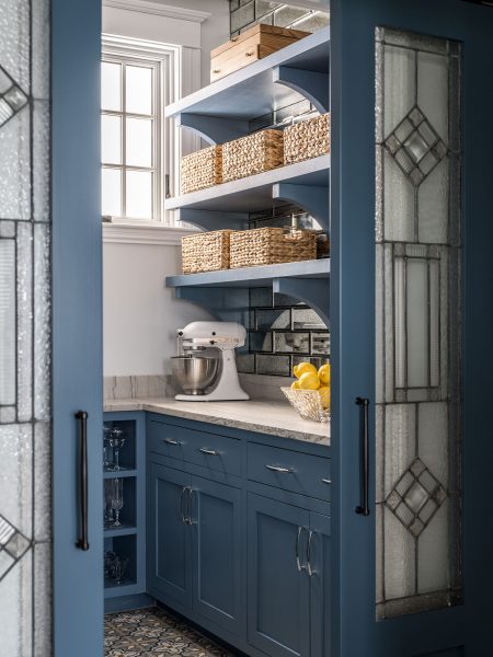Soft blue walk in pantry with plenty of storage