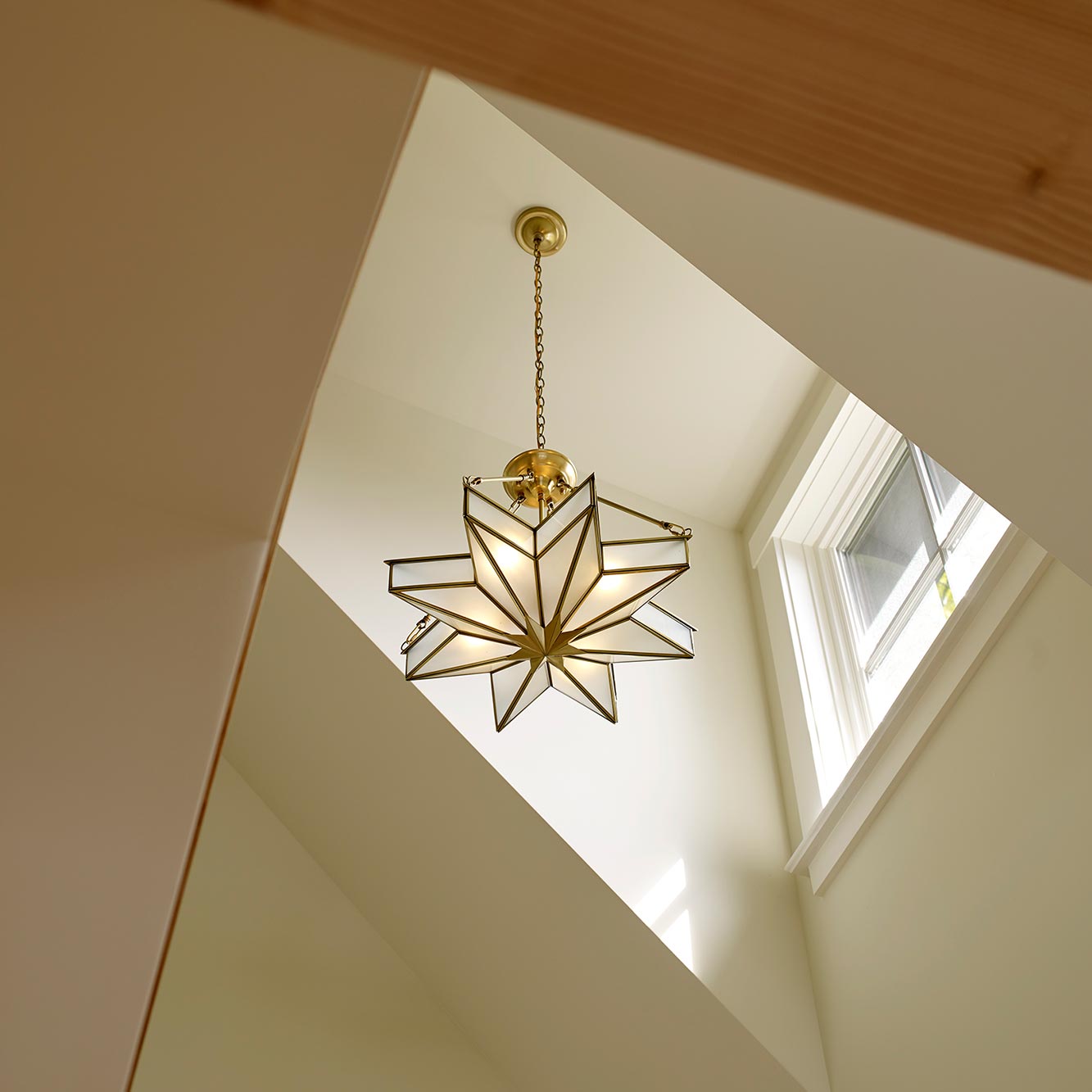 Star-shaped chandelier from the double height ceiling
