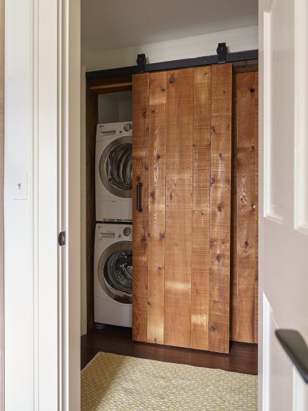 Barn style sliding doors conceal laundry room