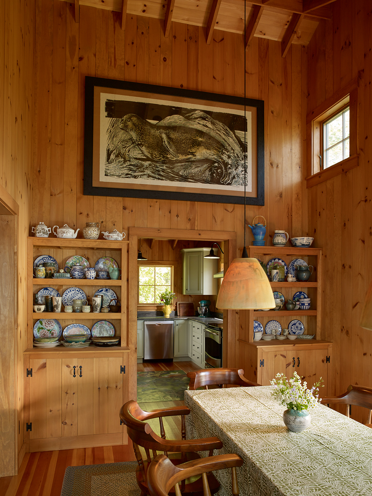 Double height dining room with built in shelves at Little Acorn Cottage