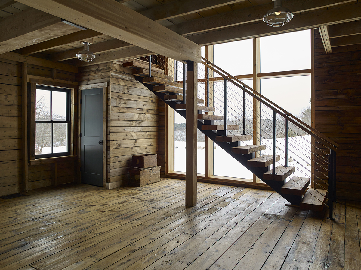 Rustic and cabin-inspired stair with large picture windows