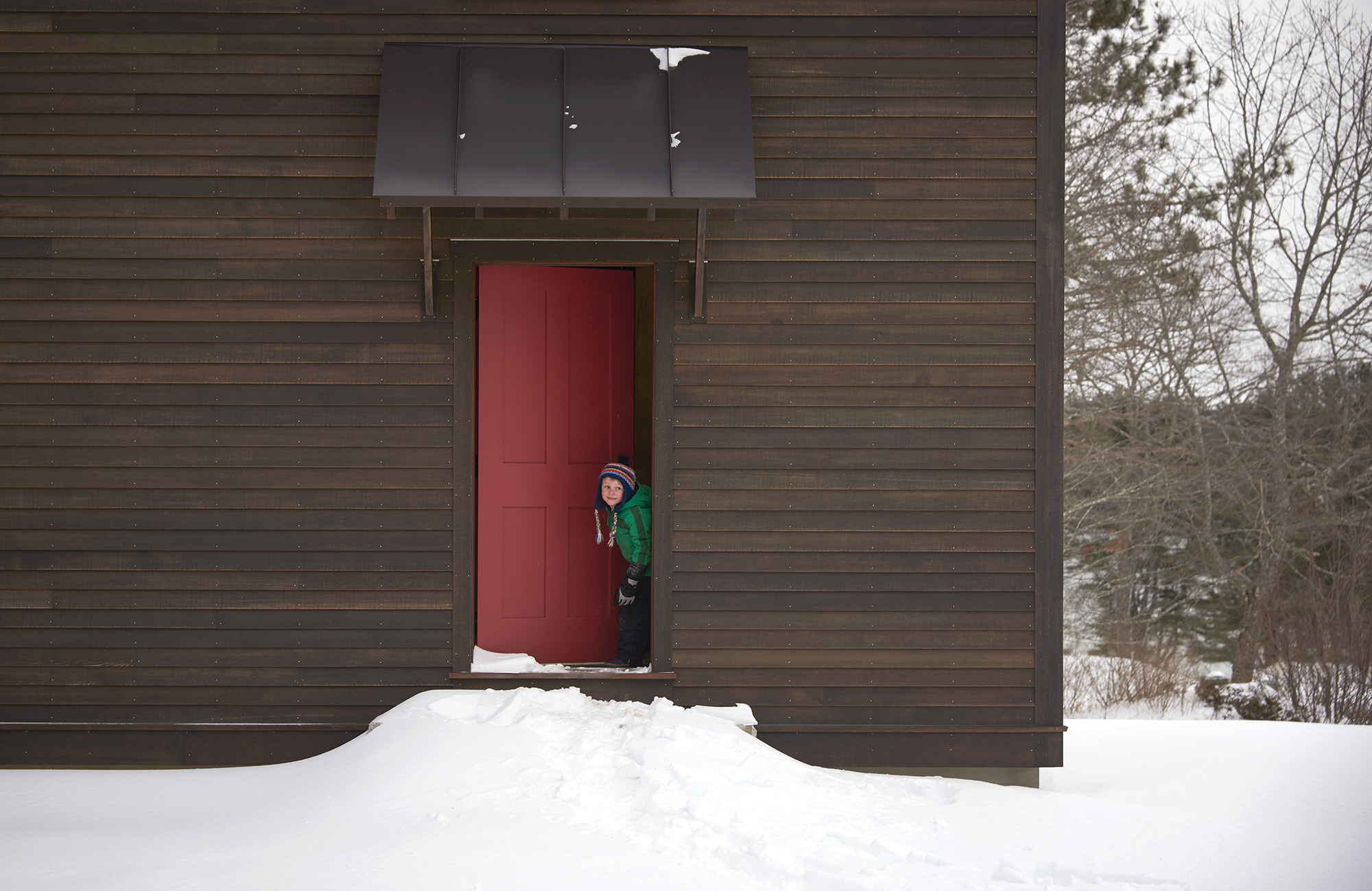 This welcoming red door couples well with the dark stain on this barn-style spa area.