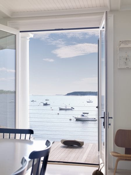Glass french doors granting access to the covered porch with views of coastal Maine.
