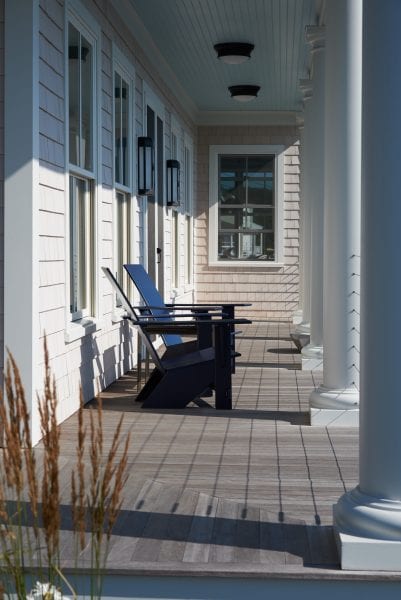Twin Cove porch with luxury adirondack chairs and wood side detailing.