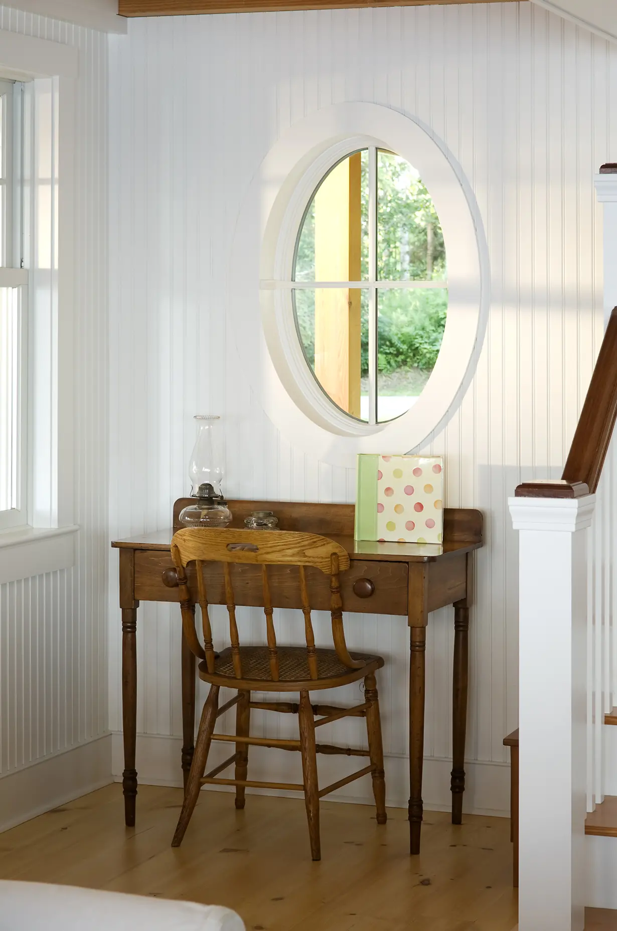 Round window detail above desk at Bayberry
