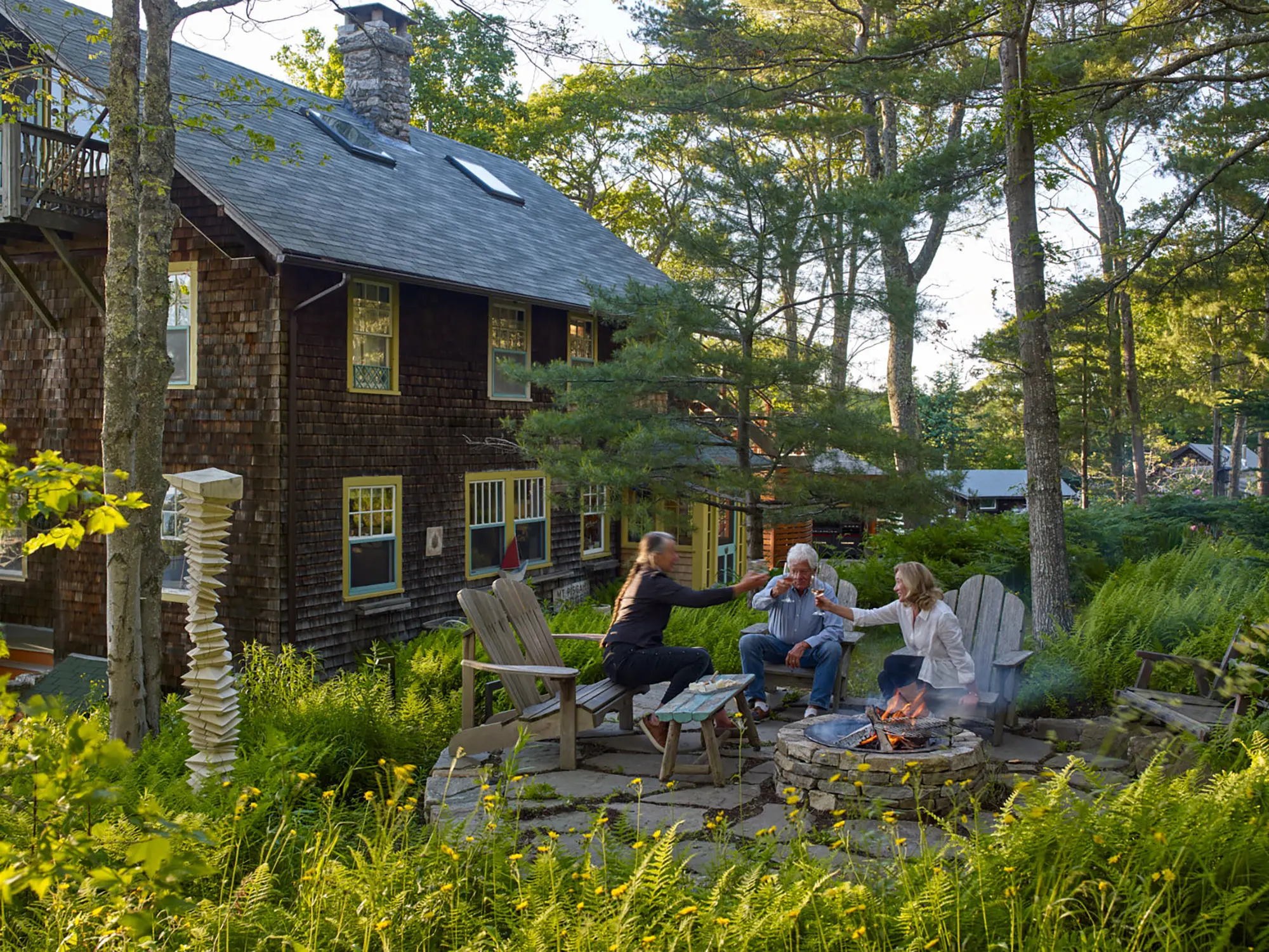 Outdoor stone patio and fireplace with cozy chairs